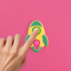 Child's hands playing with the rocket-shaped fidget keychain toy
