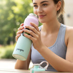 Fitness enthusiast using stainless steel water bottle during workout