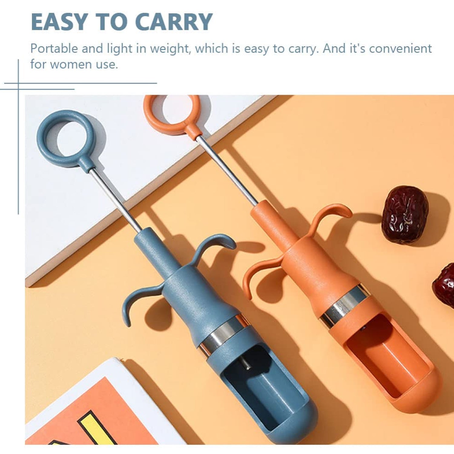 Quick cherry pitter tool shown with a pile of fresh cherries.