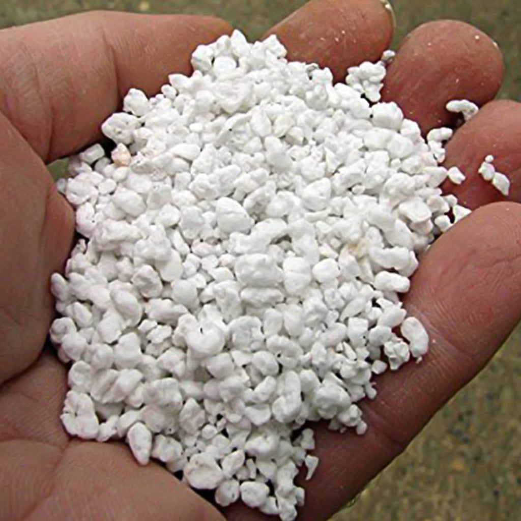 Indo Glow Perlite soil conditioner shown enhancing drainage in a plant pot.