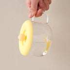 A transparent Silicone Cup Lid covering a glass cup, illustrating its universal fit.
