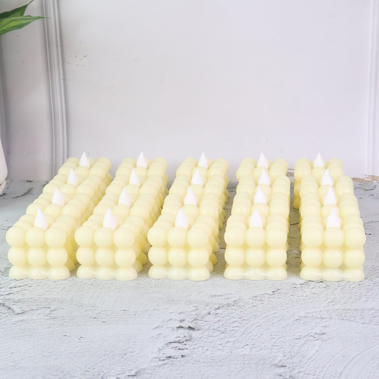 Close-up of decorative LED flameless cube candle showing bubble design and warm glow