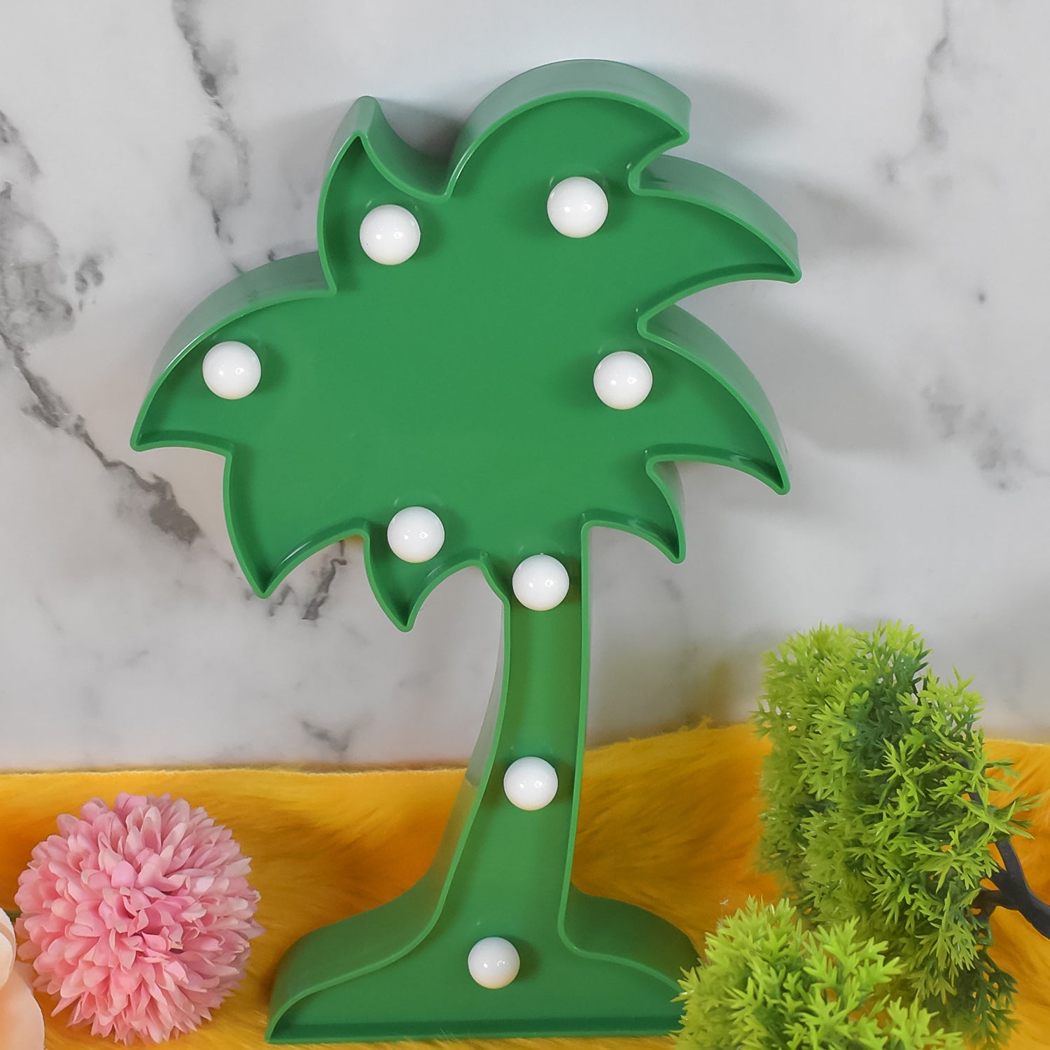 A Tidy Table Coconut Tree LED Lamp emitting a warm glow on a dark background.