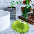 White plastic soap dish holding a bar of soap in a clean bathroom.