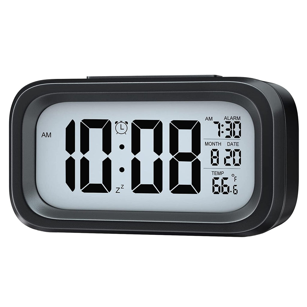 Backlit digital alarm clock displaying time at twilight