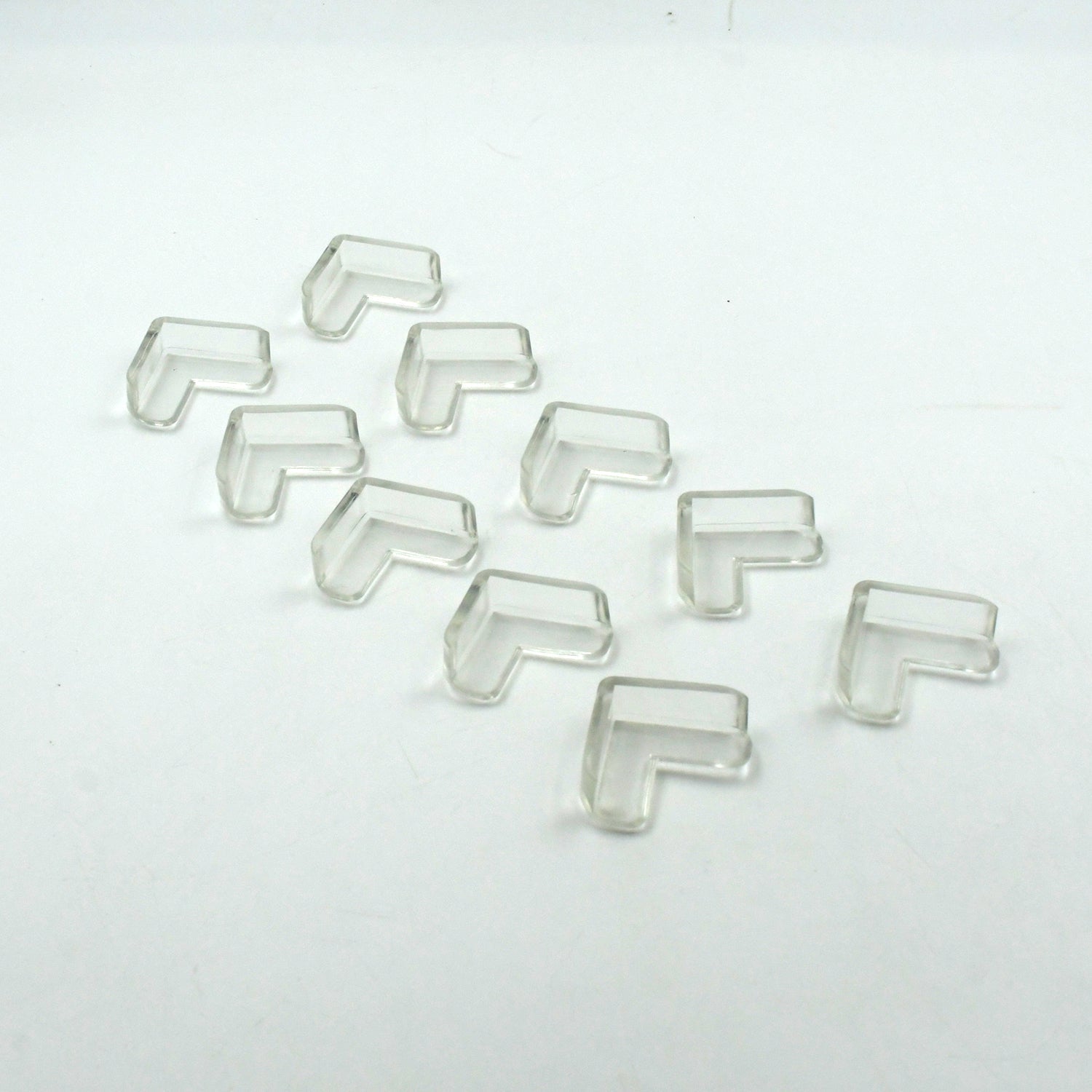 Multiple clear corner guards effectively applied to sharp furniture edges in a home.