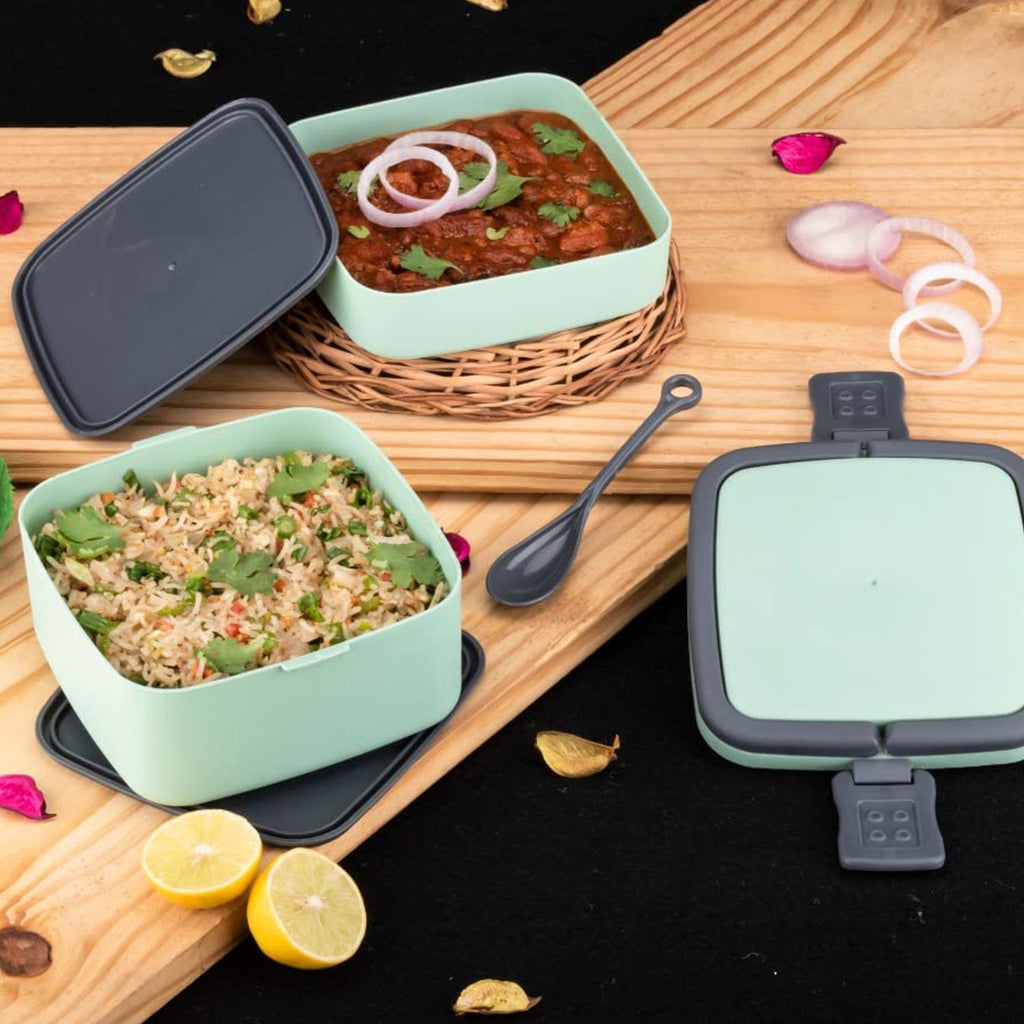 Top-down view of the open green stackable lunch box showing compartments.