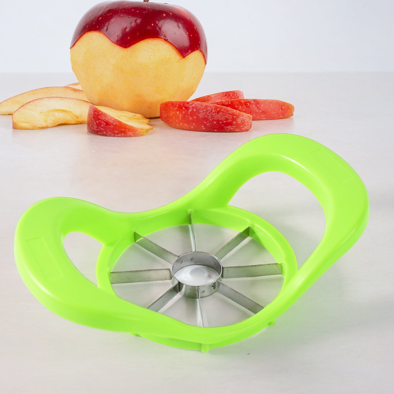 A fresh red apple being perfectly sliced by the fruit cutter.
