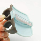 Close-up of the ergonomic Palm Peeler with its soft rubber finger grip.