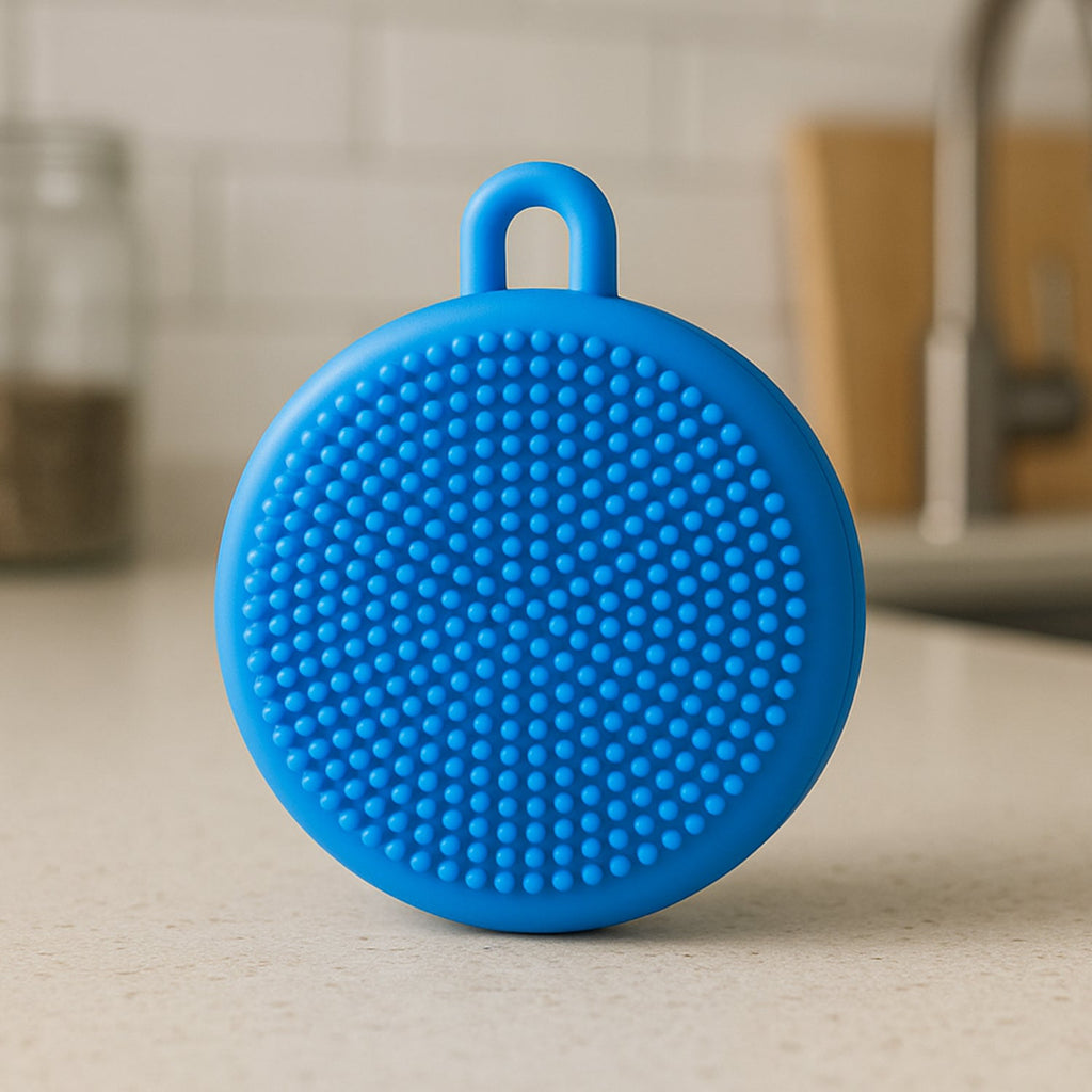 Silicone dish scrubber in a modern kitchen with sparkling clean dishes.