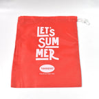 Stack of red multipurpose drawstring bags, highlighting their versatile use.