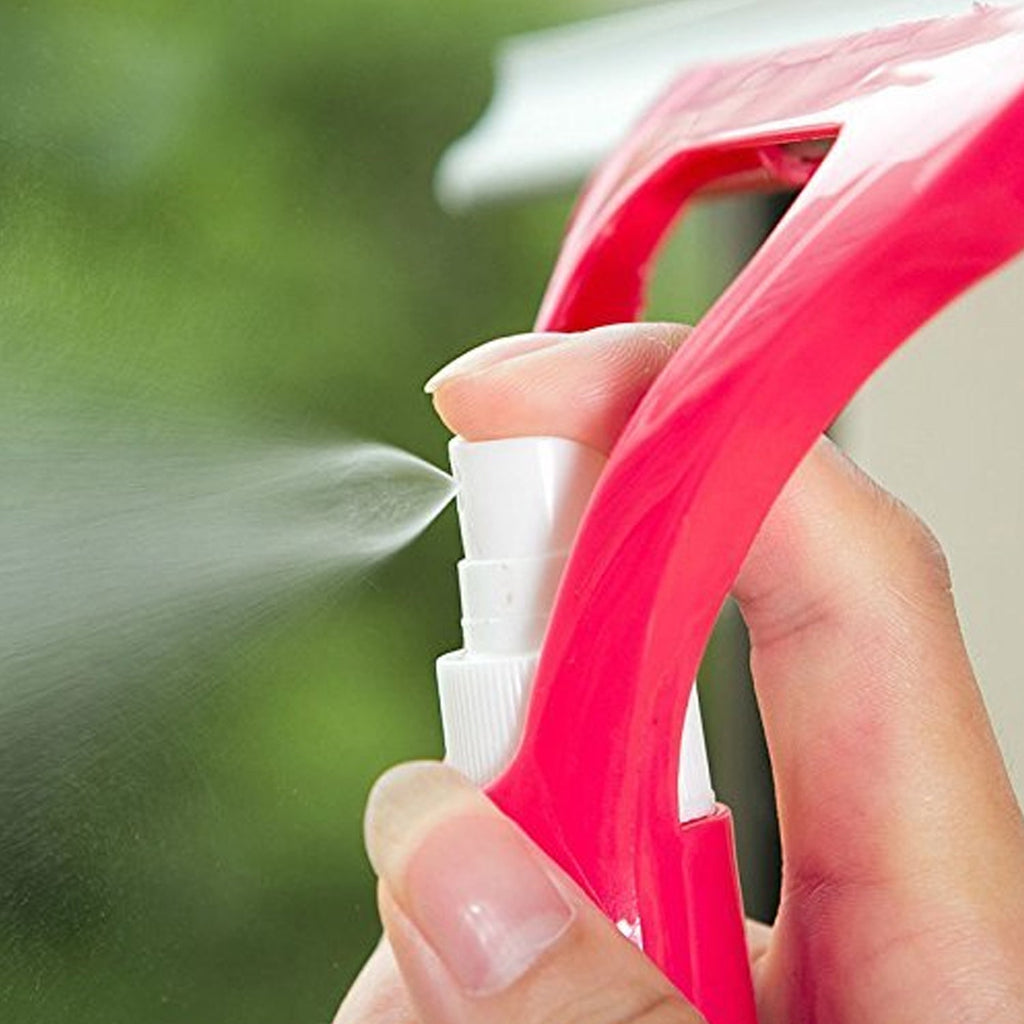 Efficiently cleaning a car windshield using the Window Cleaning Spray Brush.