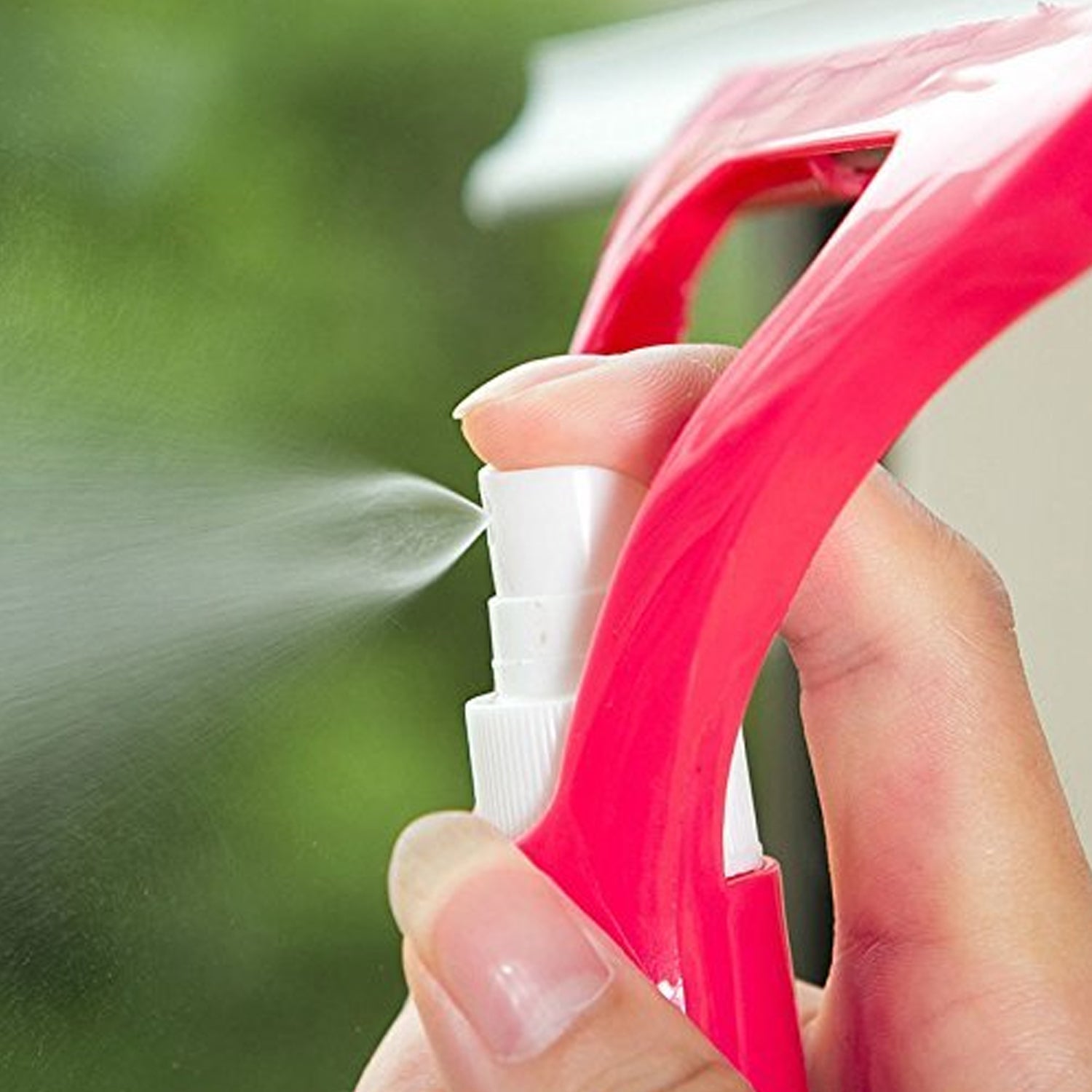 Efficiently cleaning a car windshield using the Window Cleaning Spray Brush.