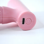 Close-up of the black mini massager's vibrating head for muscle relief.