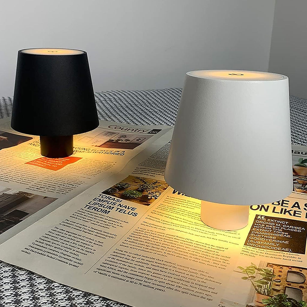 USB rechargeable wireless bottle lamp glowing inside a clear bottle on a wooden surface.