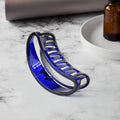 Plastic hair clamp grip with matte finish holding thick hair securely.