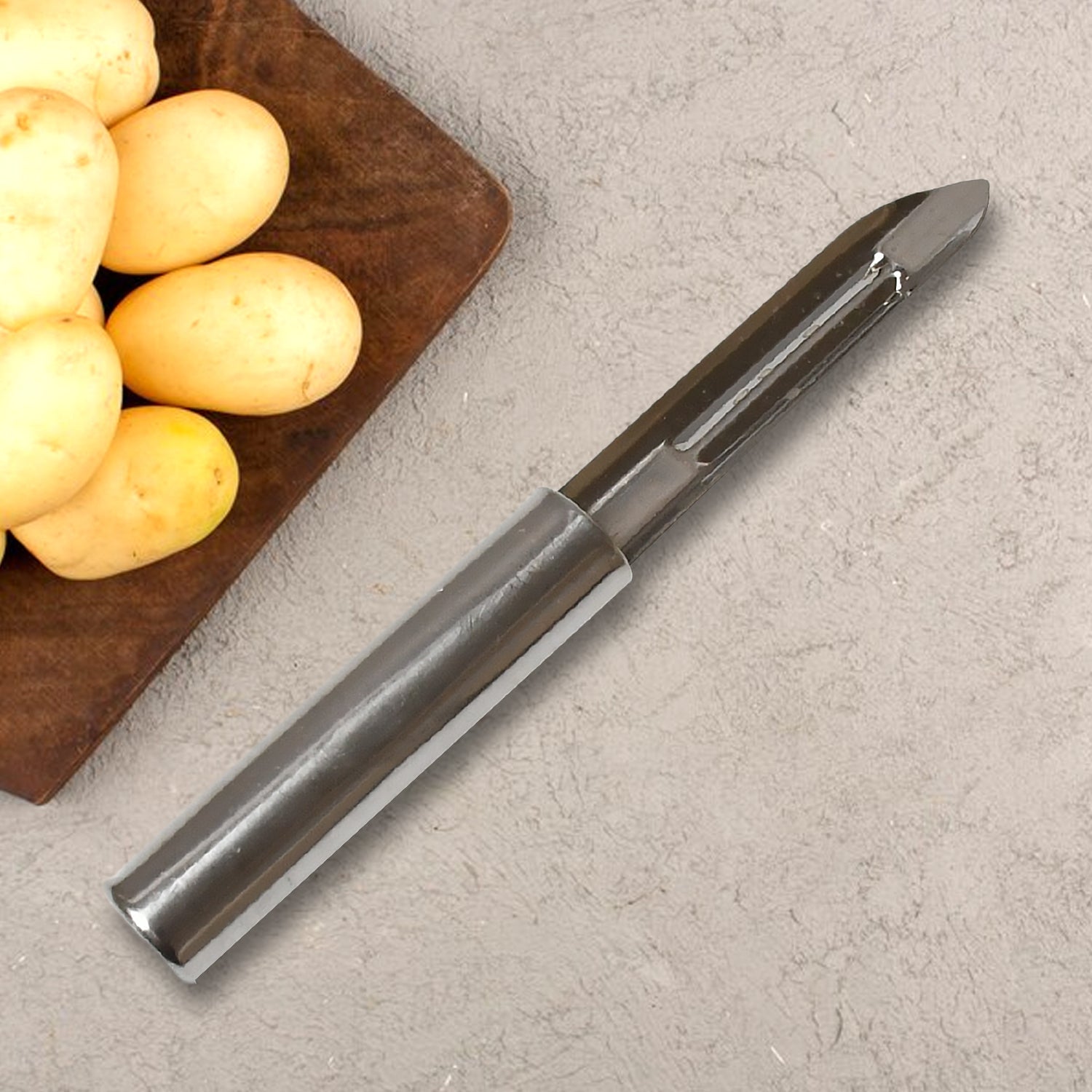 The complete stainless steel peeler set attractively arranged on a wooden cutting board with various fresh vegetables.