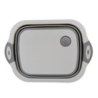 Versatile kitchen tool acting as both a cutting surface and a storage basket.