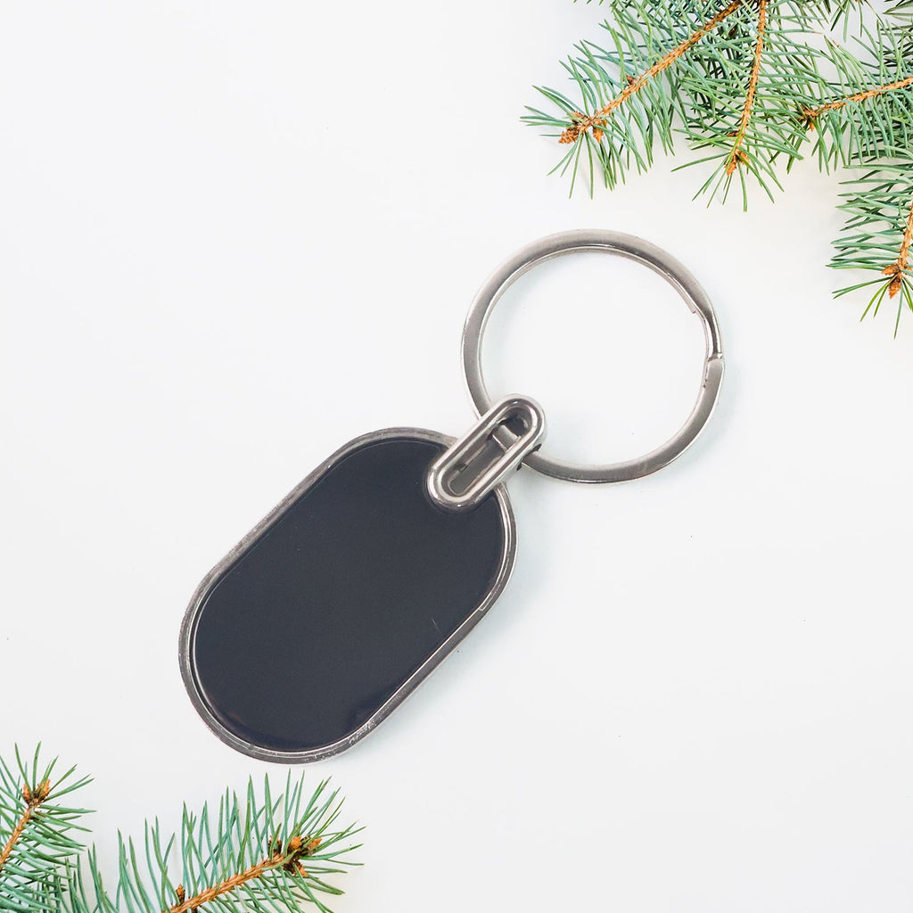 Elegant oval keychain accessory in black and silver tones
