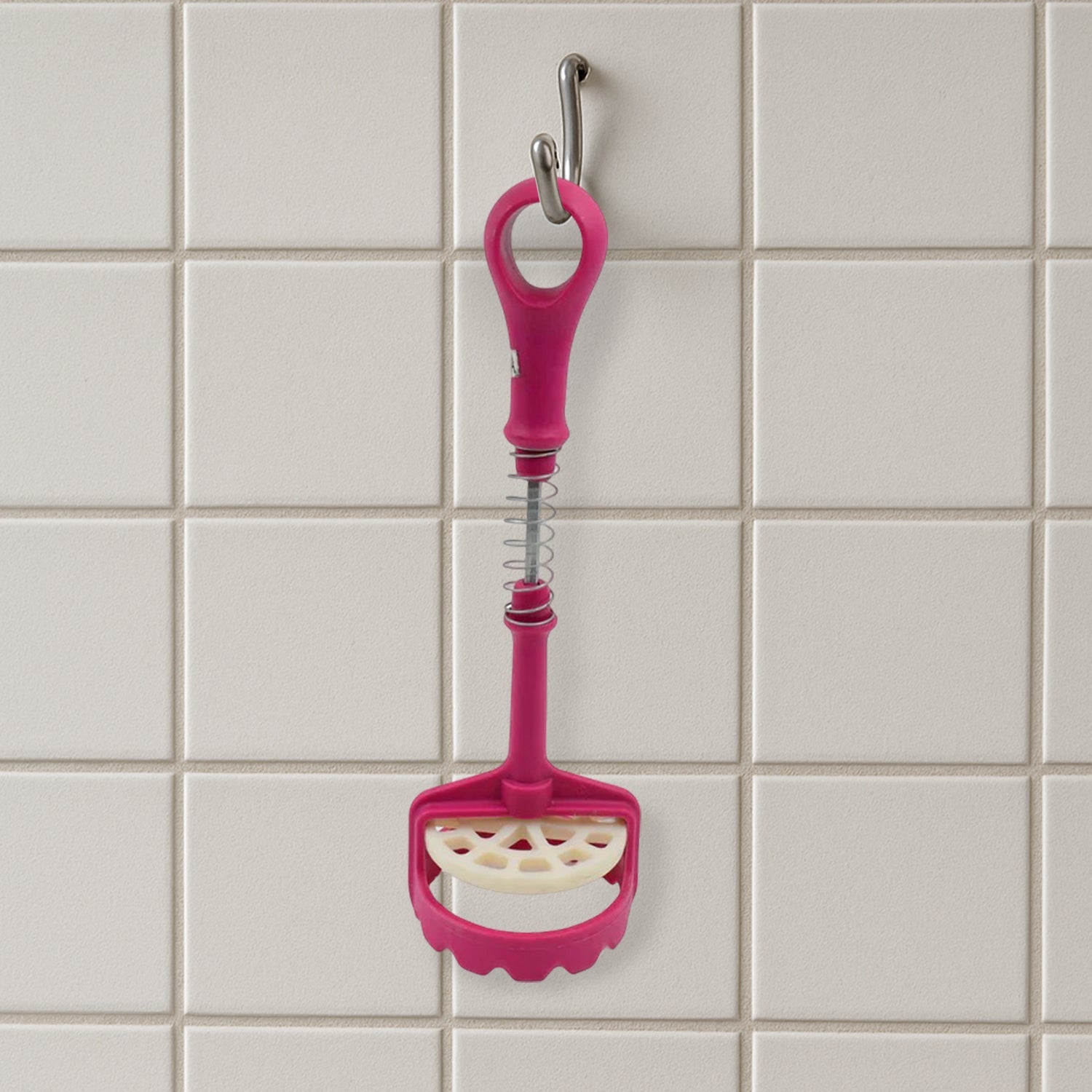 Easy-to-clean food-grade potato masher under running water.