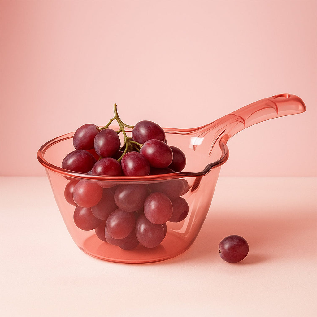 Close-up of ergonomic handle and spout on kitchen washing and straining bowl