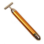 Hand holding the Golden Energy facial massage wand.