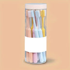 An individual soft plastic toothbrush from the set, featuring an ergonomic handle and soft bristles.