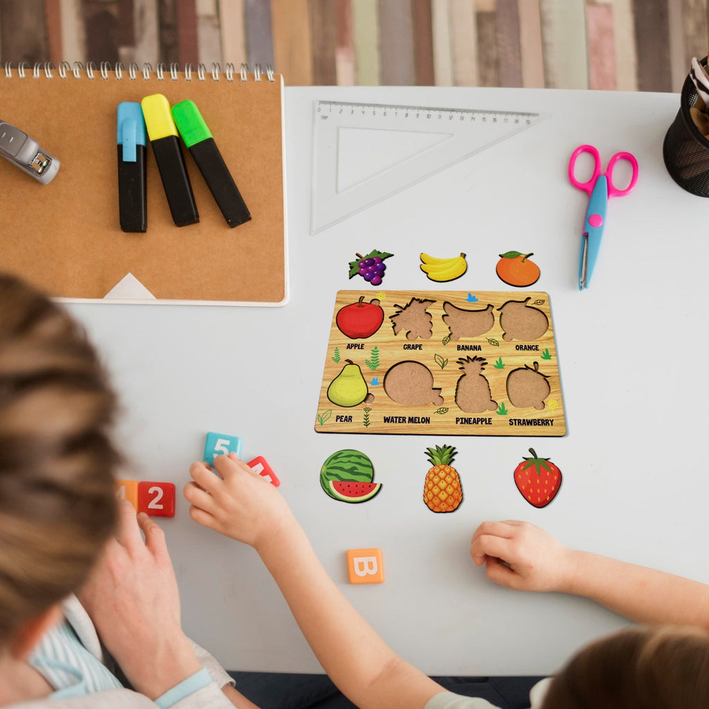 The Inventive Play wooden fruit puzzle board with all pieces neatly arranged.