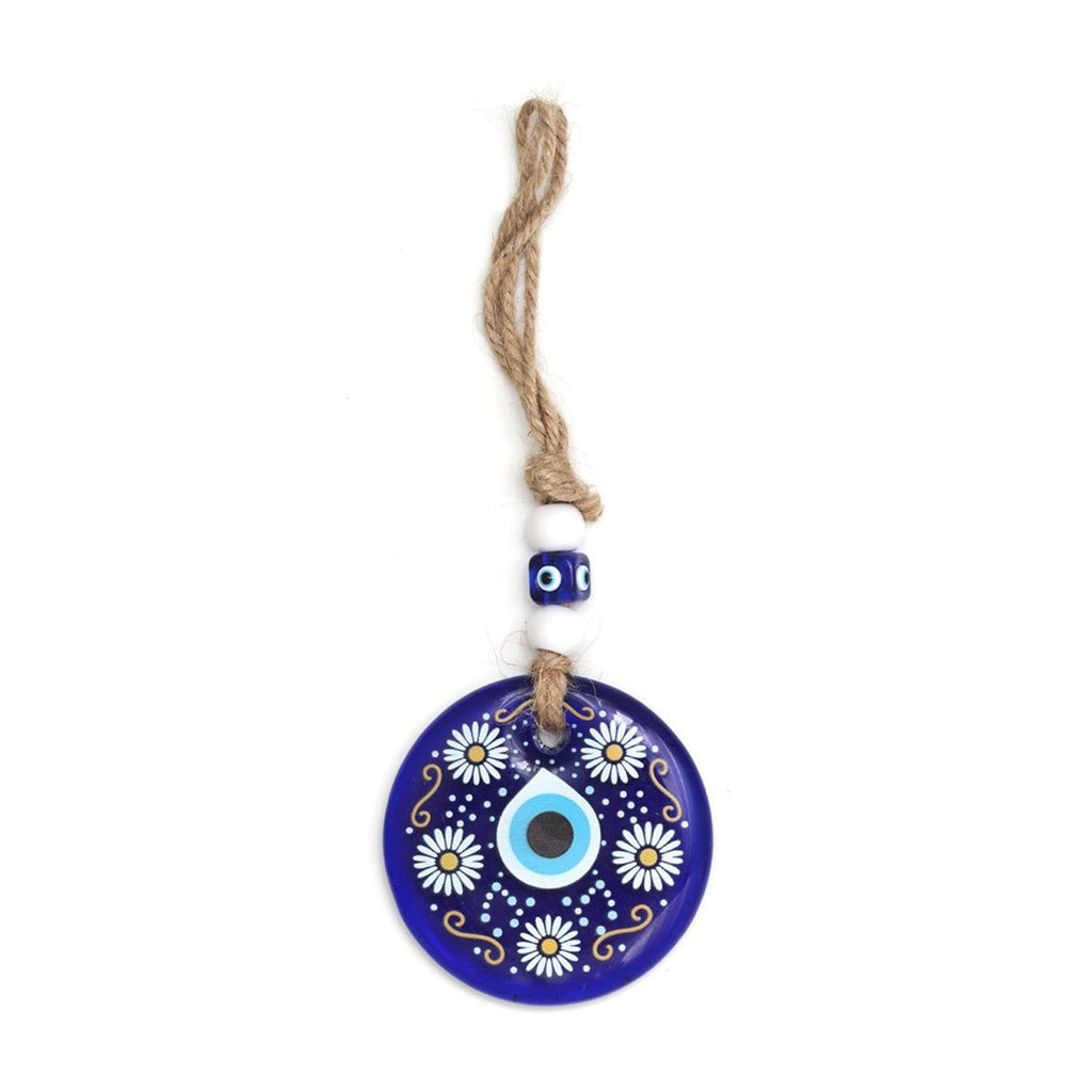 Detailed view of Evil Eye Wall Hanging's blue eye and ornamental bead accents