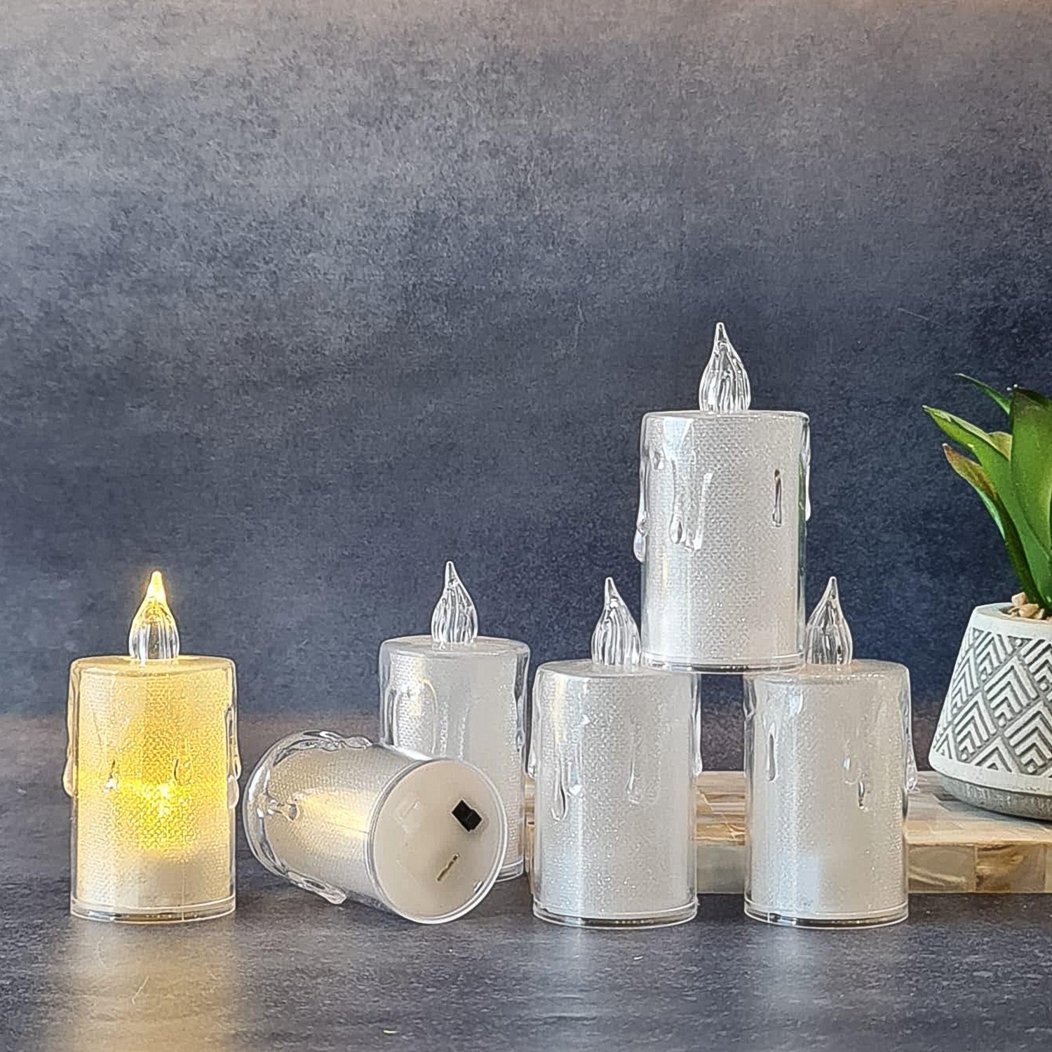 Crystal LED candle illuminating a festive corner with traditional Indian decor.