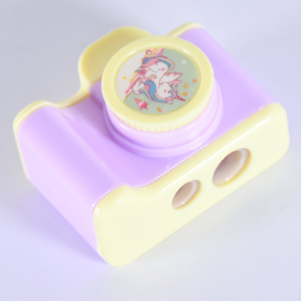 Side view of the camera shaped sharpener, highlighting its manual sharpening mechanism.