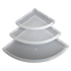Three plastic corner shelves neatly arranged, ideal for space-saving bathroom storage.