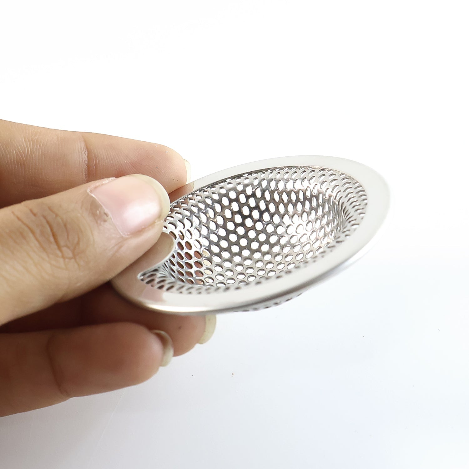 Close-up of stainless steel kitchen sink filter cup for food waste catcher