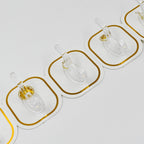 Transparent adhesive hooks installed on a white wall, blending seamlessly with home decor.