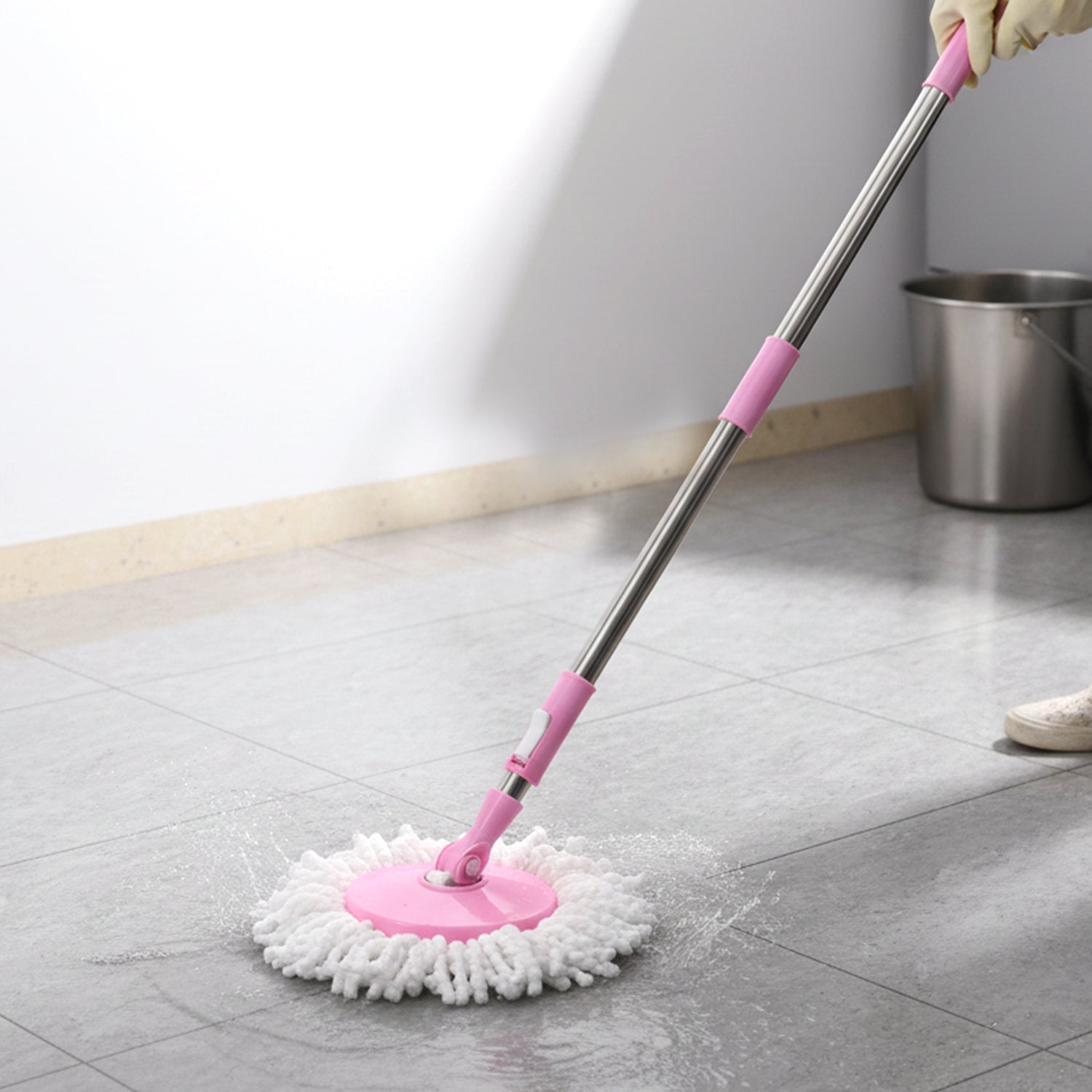 User demonstrating the simple hands-free wringing action with the Quick Spin Mop.