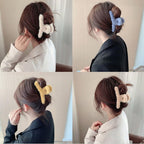Side view of a fluffy plush hair claw clip, highlighting its generous size and soft finish.