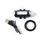 Multipurpose LED bicycle safety light attached easily, demonstrating versatile mounting.