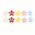 Set of colorful metal star hair clips arranged for kids and women