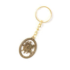 Spiritual golden keyring with detailed Durga Maa design in oval frame