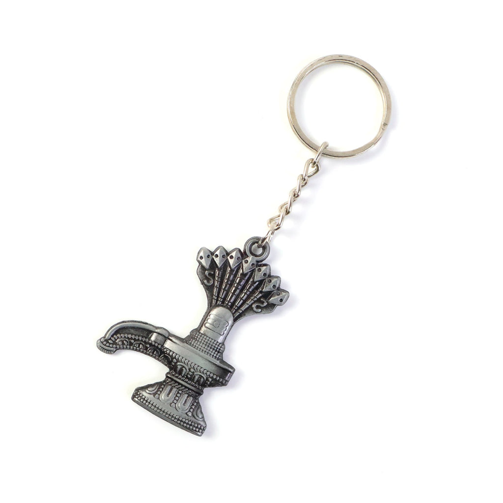 Hand holding Shiva Lingam metal keychain with spiritual Naag motif