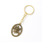 Detailed close-up shot of Maa Durga Golden Oval Frame Keychain in hand
