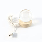 Warm glow from the 3D Crystal Ball Lamp creating a serene ambiance in a dark room.