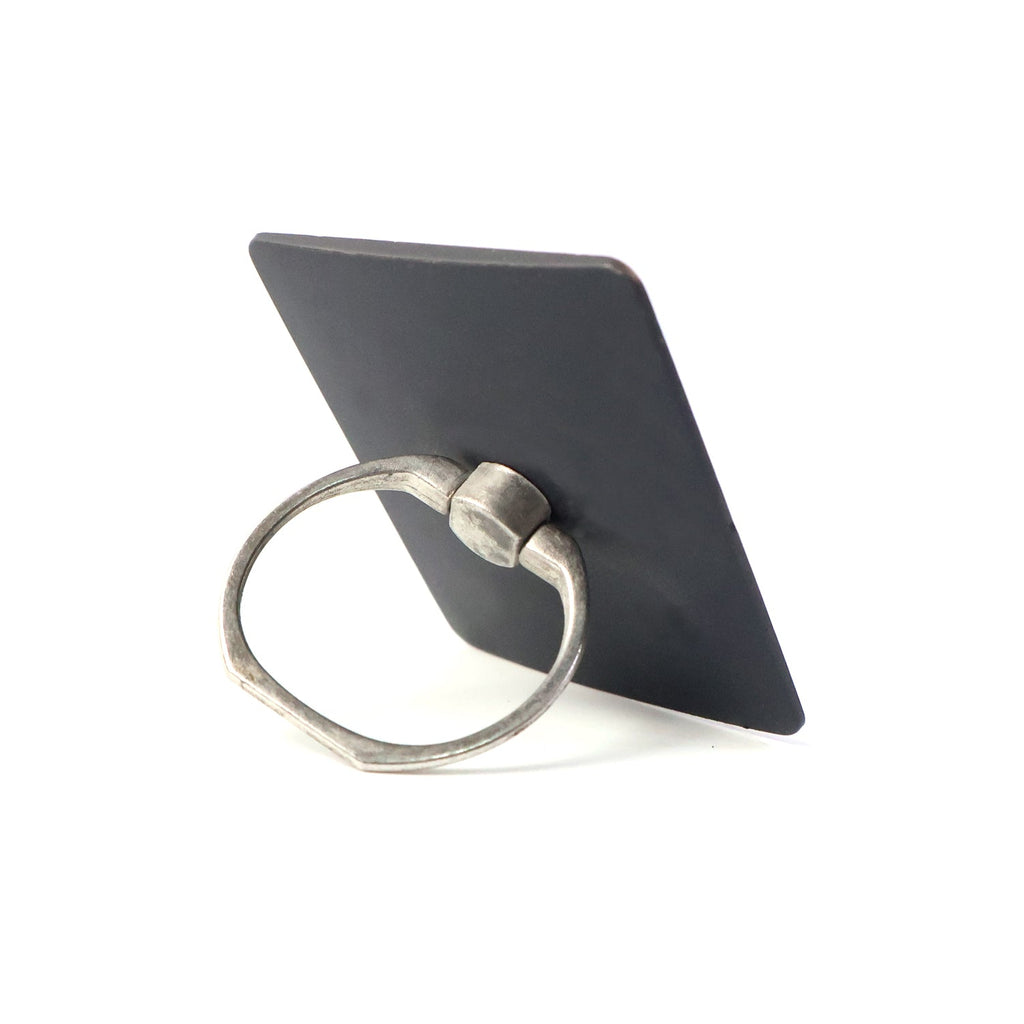 Side profile of the compact phone ring stand, highlighting its slim design.