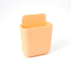 Plastic Storage Pocket mounted on wall filled with small everyday essentials