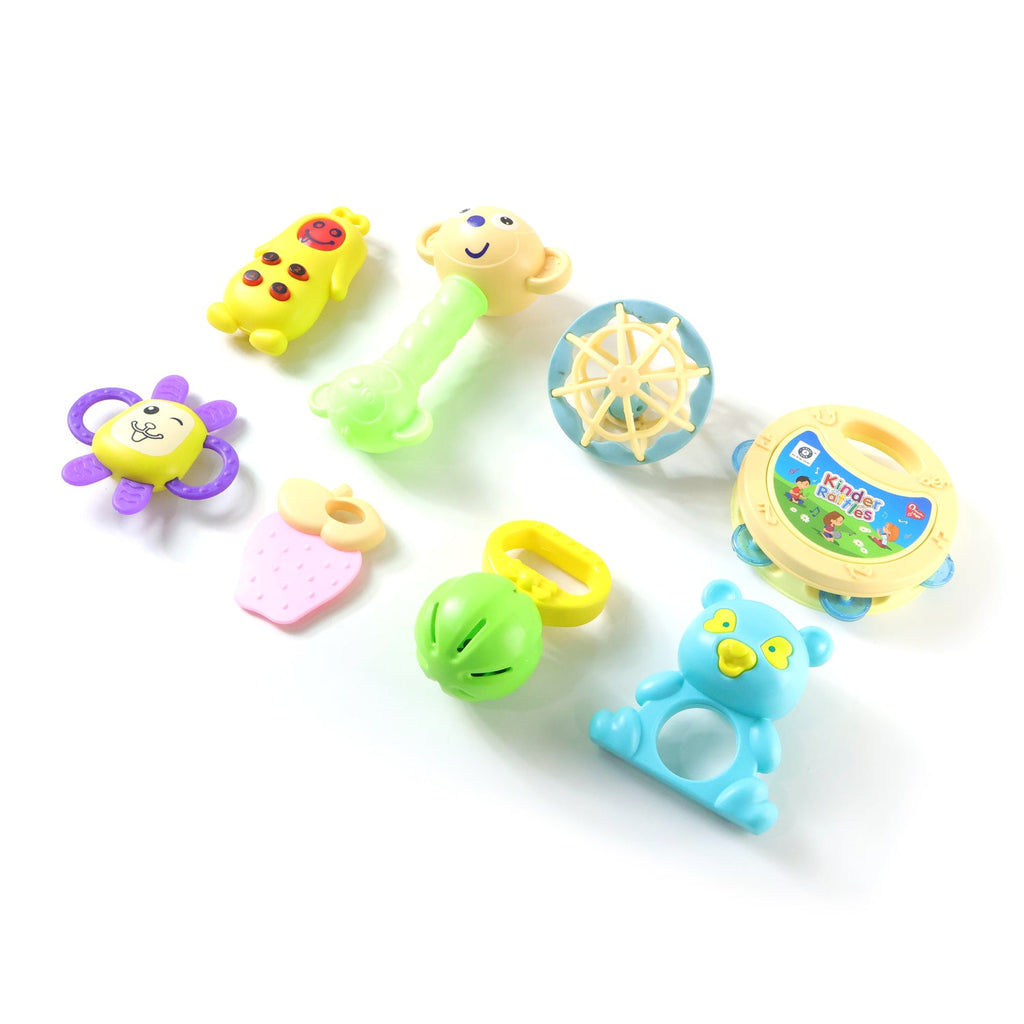 Happy baby playing with a blue and green rattle, stimulating early development.