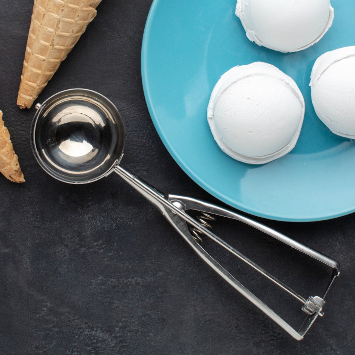 Top view of stainless steel kitchen scoop with spring-loaded release