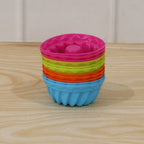 Stacked view of silicone cupcake moulds in bright colors