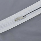 Closeup of full-length zipper on suit cover with breathable fabric.