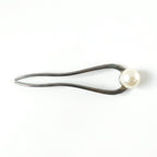 Close-up of pearl hair pin detail