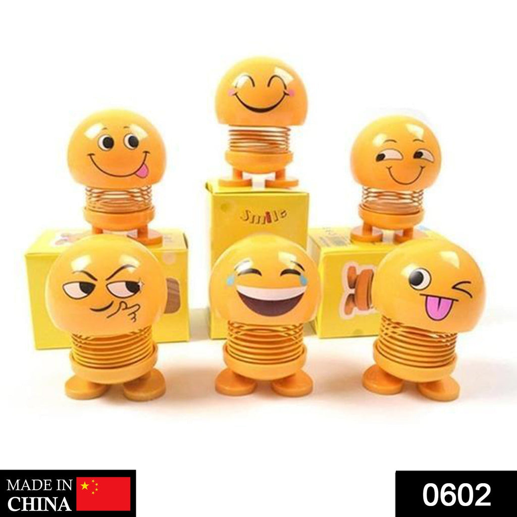 Front view of a funny bobblehead smiling face spring doll for desk decor.